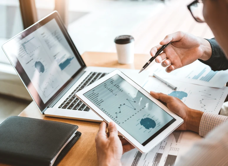 Business meeting with digital charts